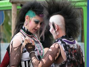 Two young people with goth style hair and clothes.